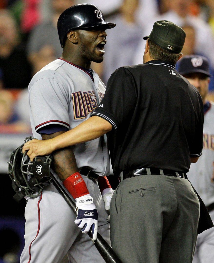 Associated Press
Elijah Dukes was restrained by Doug Eddings as he shouted at Mike Pelfrey.