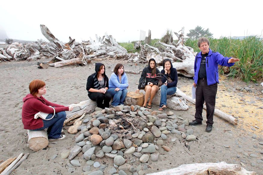 ** ADVANCE FOR SUNDAY, SEPT. 21 ** Visitors listen Friday, Sept. 5, 2008, to Michael Gurling, right, of the Forks, Wash., Chamber of Commerce, talk about the bonfire location on a beach in LaPush, Wash., that is portrayed as the place where Bella Swan, the main character in author Stephenie Meyer's vampire-themed "Twilight" books, learns that her high-school friend Edward Cullen is really a vampire. The visitors were taking part in a "Twilight Tour" led by Gurling that takes fans of the books, which are set in the nearby town of Forks, Wash., around to locations central to the plot and characters. The attention is welcome in Forks, which has long suffered by the decline in the timber industry. (AP Photo/Ted S. Warren)