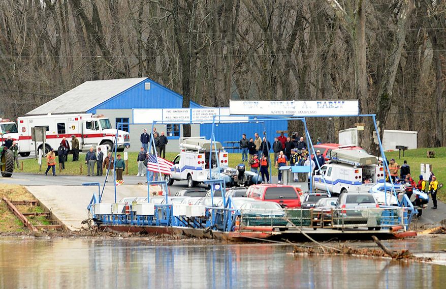 Barbara L. Salisbury/The Washington Times File
People wait on the Maryland shoreline in Poolesville on as their vehicles are brought back to shore on the White's Ferry, which carries commuters between Loudoun and Montgomery counties.
