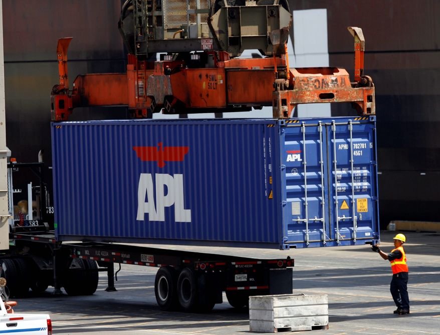 ** FILE ** A longshoreman readies a container for shipment at the APL Terminal at the Port of Los Angeles on Aug. 28, 2008. (Associated Press)