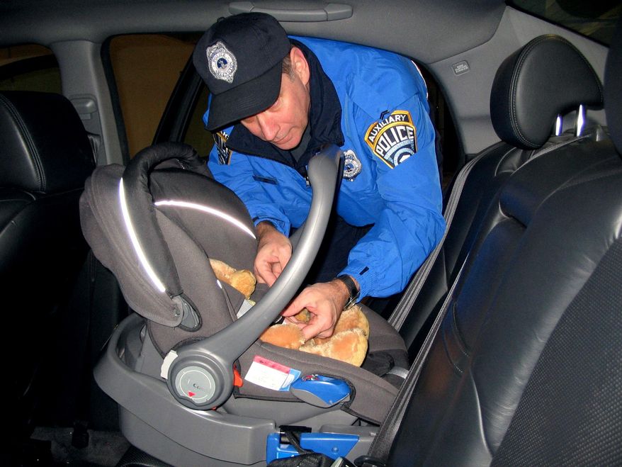 A furry friend helps Auxiliary Police Cpl. James Murphy demonstrate harness use in a child-safety seat.