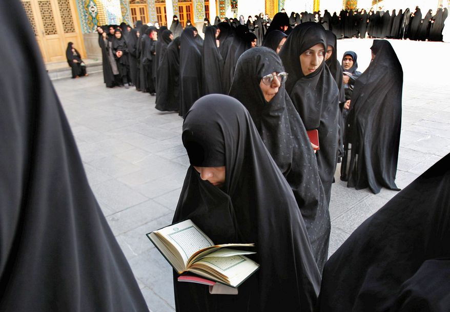 ** FILE ** This 2009 file photo shows Iranian women lining up to cast their vote in the country's contentious presidential elections. (Associated Press)