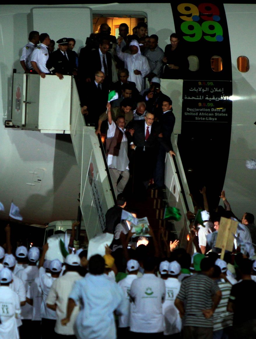 ** FILE ** A cheering crowd greets Lockerbie bombing convict Abdel Baset al-Megrahi on his return to Libya after being freed from prison by a Scottish judge. (ASSOCIATED PRESS)