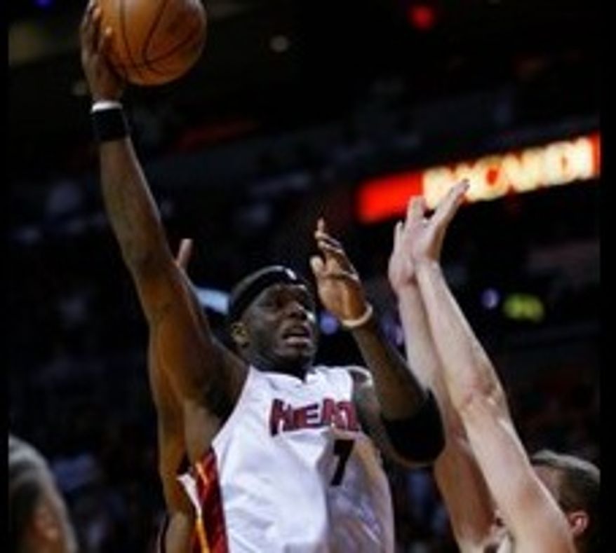 Associated Press
Jermaine O'Neal had 22 points and 12 rebounds for the Heat in their season opener.