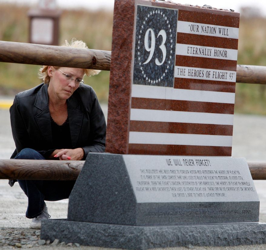 Jan Edwards of Lebanon, Ohio, stops to read the inscription on a marker at the temporary memorial for those who died in the Flight 93 crash on Sept. 11 in Shanksville.
