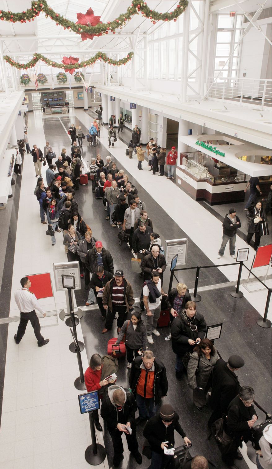 ** FILE ** Passengers at Chicago's O'Hare International Airport prepare to go through security in December 2009.