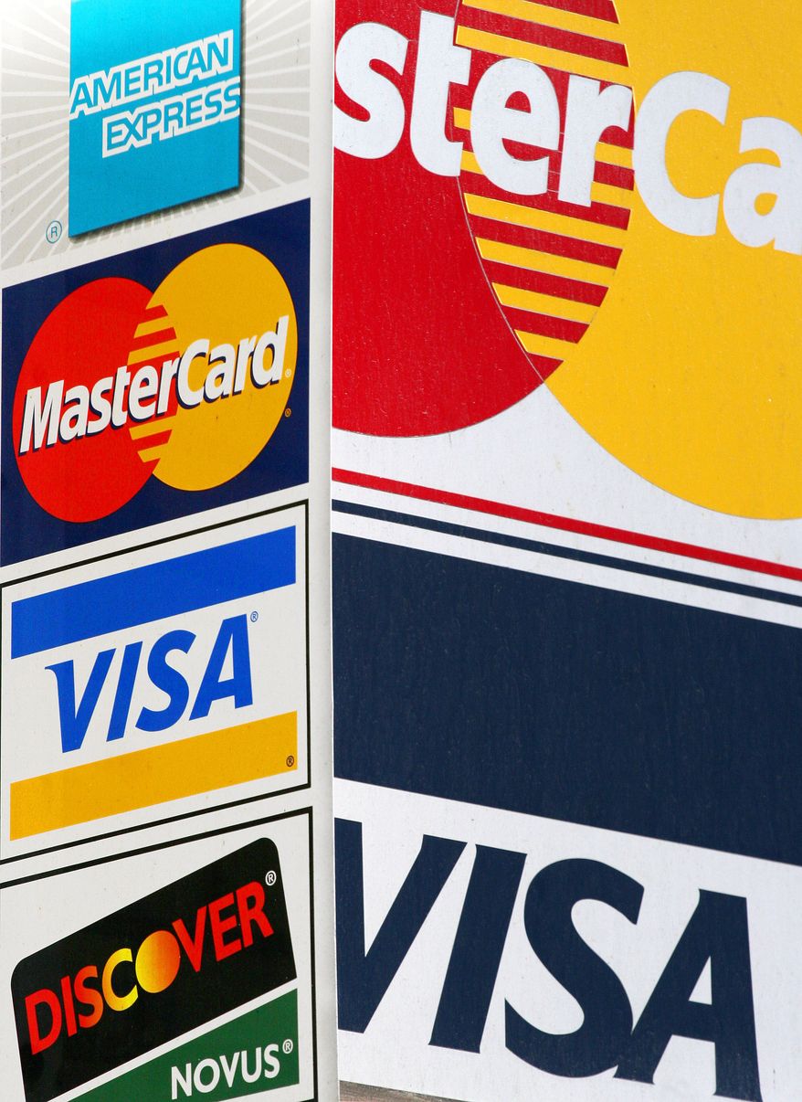 ** FILE ** - Credit card signs are posted outside a New York parking garage in 2006. (AP Photo/Mark Lennihan, File)