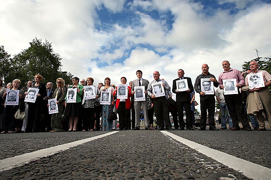 Relatives of those shot dead on Bloody Sunday march in silence in Londonderry, Northern Ireland, on Tuesday, June 15, 2010, ahead of the release of the long-awaited Saville Report. The British government is publishing the findings of the investigation into Bloody Sunday, the 1972 killing of 13 Catholic demonstrators by British troops. The investigation began in 1998 and became the most expensive in British legal history as it gathered evidence from 2,500 witnesses, including troops who opened fire that day. (AP Photo/Paul Faith/PA Wire)