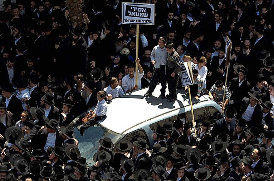 Ultra-Orthodox Jewish men demonstrate in Bnei Brak, Israel, on Thursday, June 17, 2010, to protest an Israeli Supreme Court ruling forcing the integration of a religious girls school. (AP Photo/Ariel Schalit)