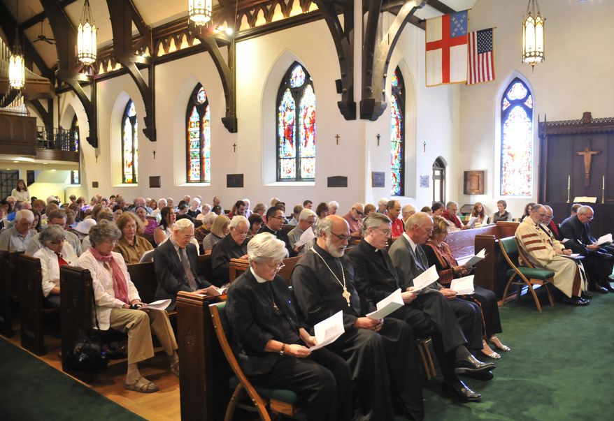 People reflect on Ronnie Lee Gardner's death penalty by singing, prayers, and reading at St. Mark's Cathedral in Salt Lake City, Thursday, June 17, 2010, hours before Gardner was executed by firing squad. (AP Photo/Deseret News, Matt Gillis)