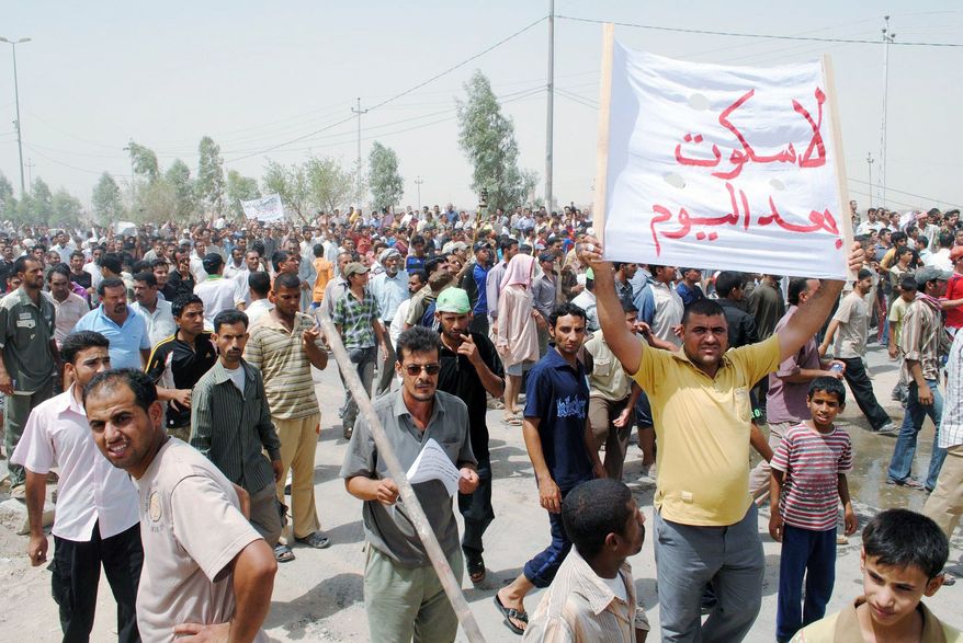 Iraqis protest power cuts in Nasiriyah, about 200 miles southeast of Baghdad, for a second day on Monday. Riot police in southern Iraq used water cannons to disperse protesters who were pelting them with stones. (Associated Press)