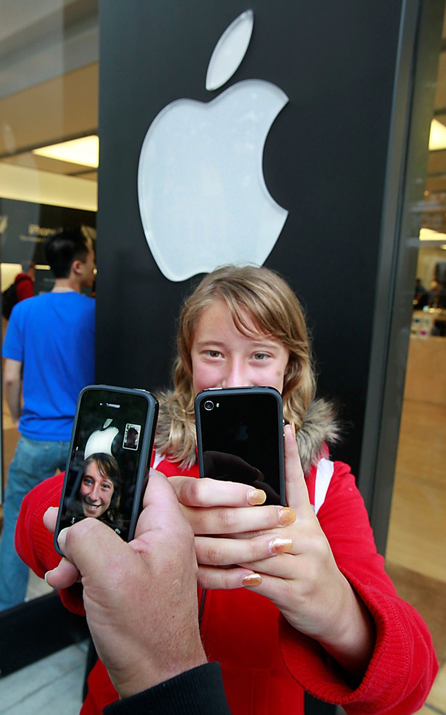 Emilie Weideman and her father, Marc Weideman, of Fremont, Calif., uses the new Apple iPhone 4 program FaceTime after purchasing the new device. (AP Photo/Paul Sakuma)