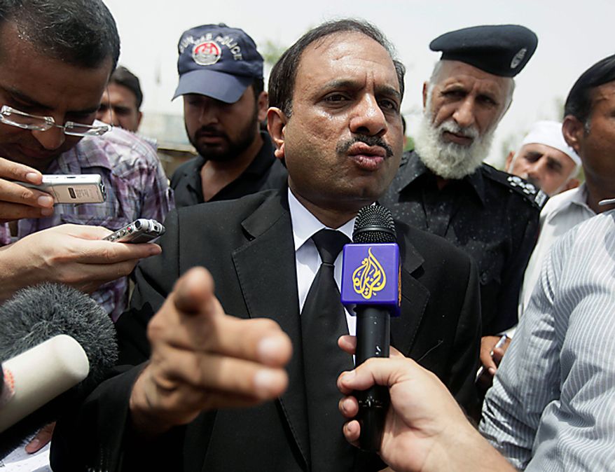 Deputy prosecutor Rana Bakhtiar is mobbed by the press outside the district jail where five young Muslims from the Washington, D.C. area who were arrested in Pakistan in December are being held, in Sargodha, Pakistan, Thursday, June 24, 2010. The five American men were convicted Thursday on terror charges by a Pakistan court and sentenced to 15 years in prison each, the prosecutor said. The judge handed down two prison terms for each man, one for 10 years and the other for five, said Bakhtiar. (AP Photo/Dita Alangkara)