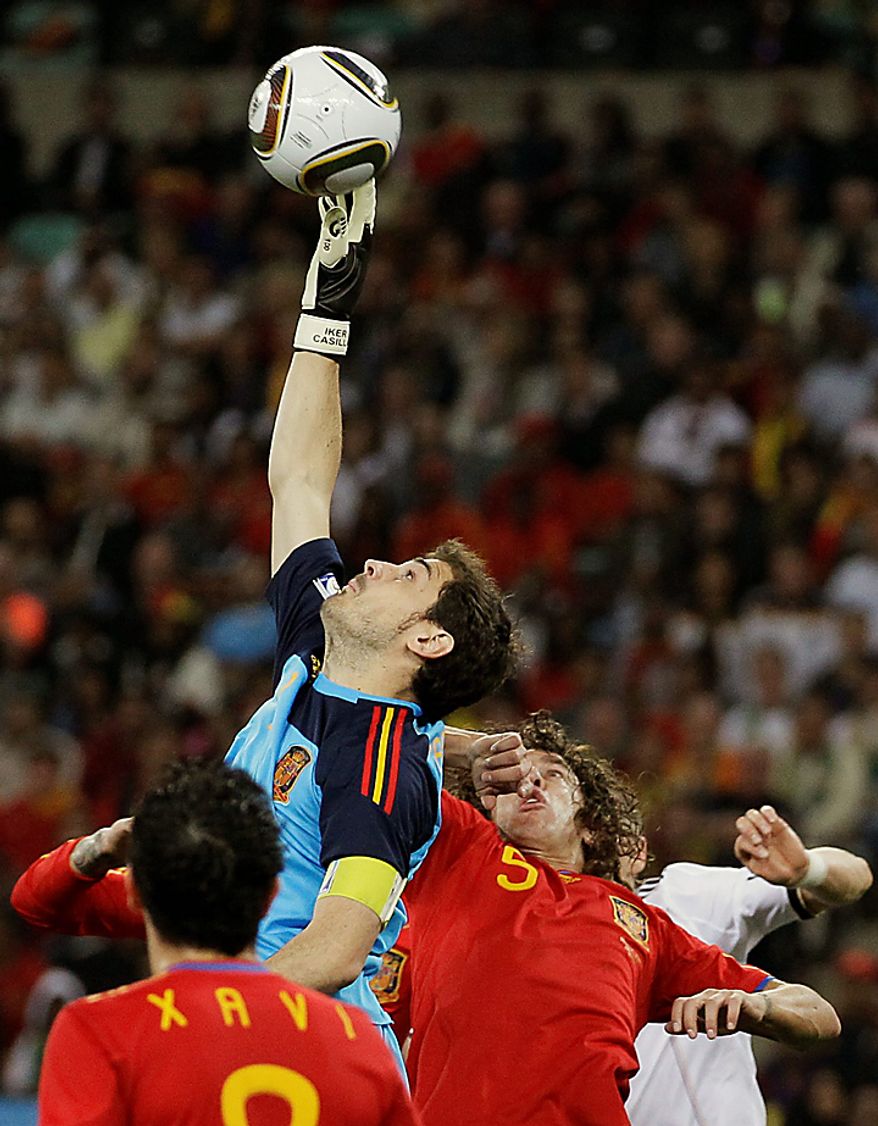 Spain goalkeeper Iker Casillas, center top, makes a save during the World Cup semifinal soccer match between Germany and Spain at the stadium in Durban, South Africa, Wednesday, July 7, 2010. (AP Photo/Ivan Sekretarev)