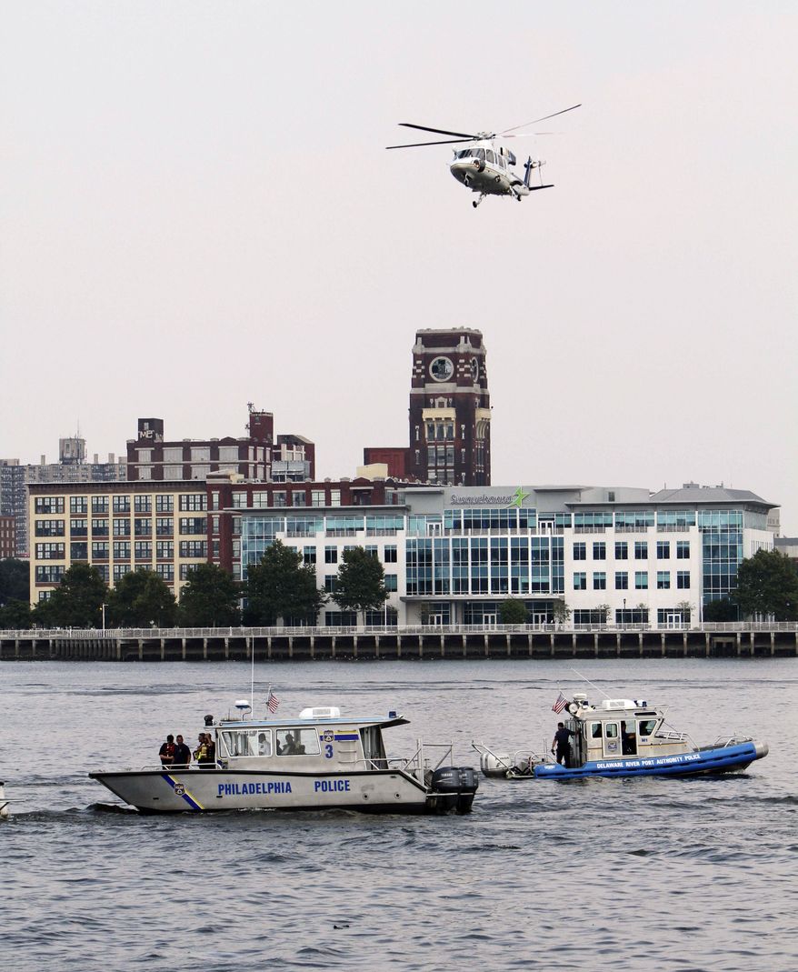 Rescue vessels are seen on the Delaware River in Philadelphia, Wednesday, July 7, 2010. Coast Guard officials say a barge collided with a tourist duck boat on the Delaware River in Philadelphia. (AP Photo/ Joseph Kaczmarek)