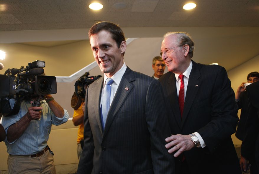 Sen. John D. Rockefeller IV (right), West Virginia Democrat, escorts Carte Goodwin on Capitol Hill on Tuesday, July 20, 2010, before Mr. Goodwin, also a Democrat, is sworn in as the Mountain State's junior senator. (AP Photo/J. Scott Applewhite)