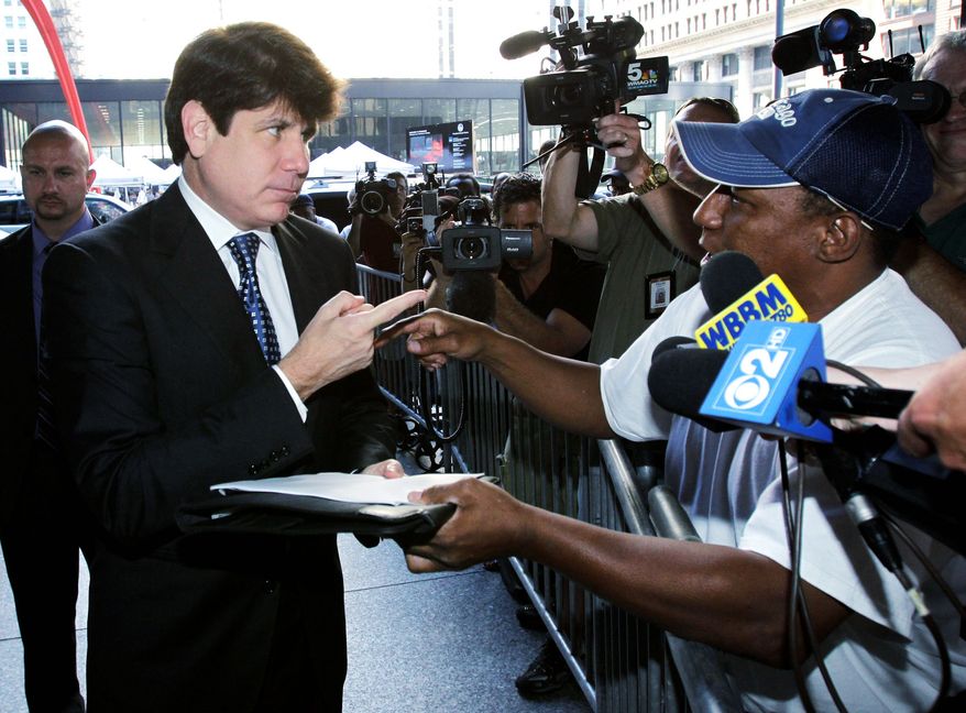 Ousted Illinois Gov. Rod R. Blagojevich talks with Darrell Murphy as he arrives at federal court Tuesday for closing arguments in his corruption trial. The case now is in the jury's hands. (AP Photo)