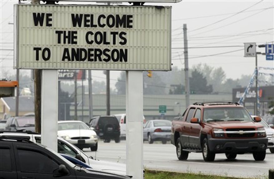 In this photo taken Sunday, Aug. 1, 2010, Indianapolis Colts head coach Jim Caldwell, left, talks with Anderson Mayor Kris Ockomon as the members of the Colts arrive for the NFL football training camp in Anderson, Ind. (AP Photo/Darron Cummings)