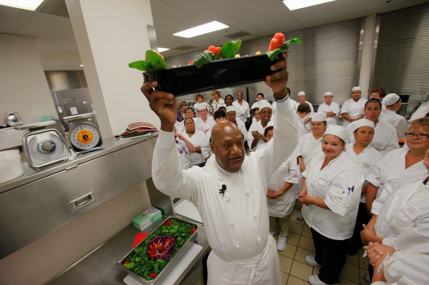 Chef Daniel Young chooses the winning fruit salad tray made by Denver public schools food-service personnel during a half day of instruction on how to use fresh foods to make healthier options for students. (Associated Press)