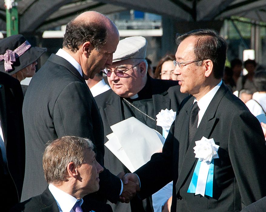 In this photo provided by the City of Hiroshima, U.S. Ambassador to Japan John Roos, left, greets Hiroshima city's Mayor Tadatoshi Akiba on his arrival at the Hiroshima Peace Memorial Park to attend the 65th anniversary of the world's first atomic bombing in Hiroshima, western Japan Friday, Aug. 6, 2010. The United States sent its first ever delegation to the ceremony marking the anniversary of the attacks. (AP Photo/City of Hiroshima)