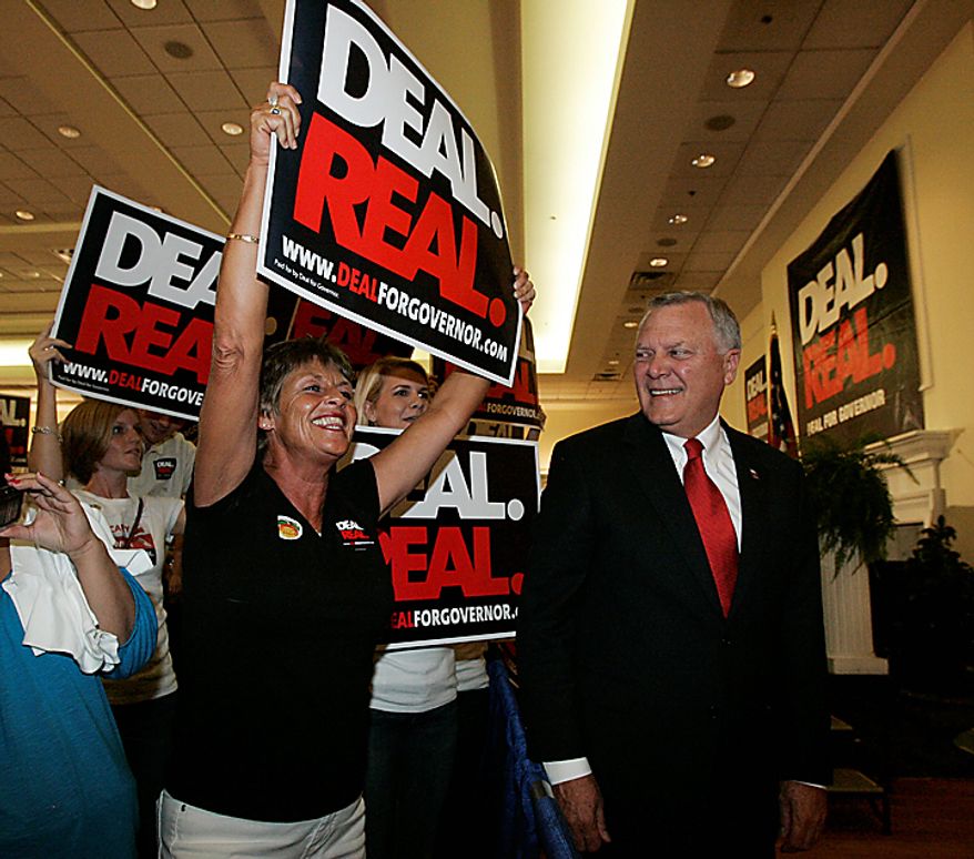 Georgia gubernatorial candidate Nathan Deal, right, looks at supporter Kay Brady of Gainesville express her enthusiasm during a Republican primary runoff election gathering Tuesday, Aug. 10, 2010, in Gainesville, Ga. (AP Photo/John Amis)