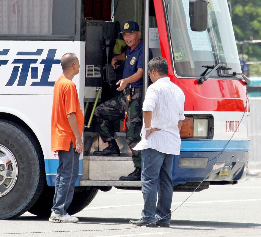 Rolando Mendoza, a dismissed police officer, talks to negotiators during a standoff where he held hostages in a tour bus. Mendoza was later killed after he wounded a police sharpshooter. (Associated Press)