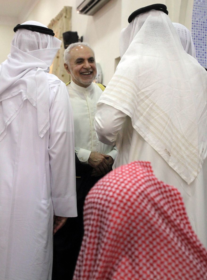 FILE - In this Aug. 20, 2010 file photo, Imam Feisal Abdul Rauf, standing center, executive director of the Cordoba Initiative, greets worshipers inside a Muharraq, Bahrain, mosque after leading midday prayers. Rauf is now in the midst of a polarizing political, religious and cultural debate over his plans for a multi-story Islamic center that will feature a mosque, health club and theater about two blocks north of ground zero in New York. (AP Photo/Hasan Jamali, File)