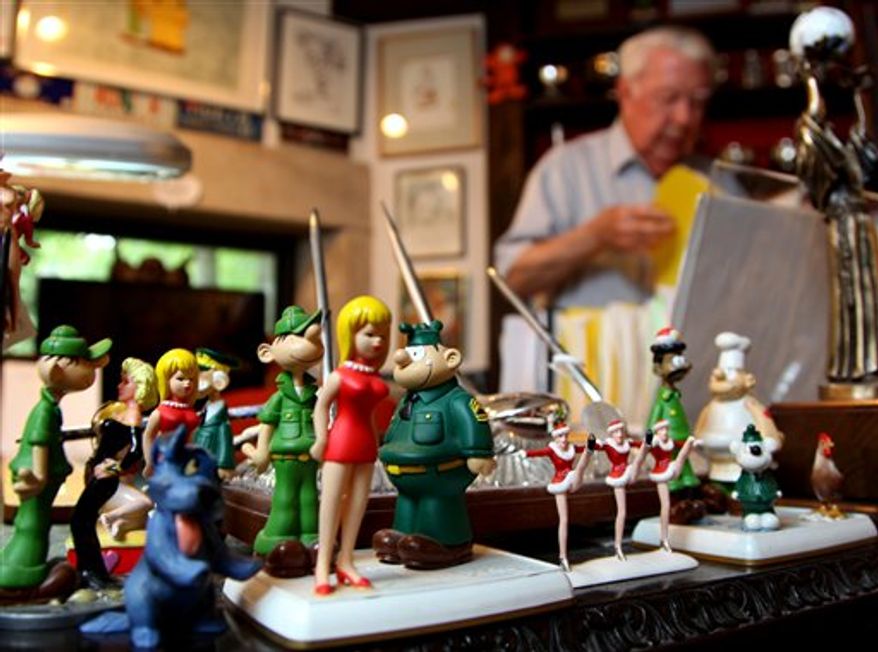 In this Aug. 16, 2010 photo, Mort Walker, the artist and author of the Beetle Bailey comic strip, speaks in his Stamford, Conn., studio about his decades of work, in this case a caricature he and other cartoonists drew of President Lyndon Johnson (Walker describes drawing Johnson's ears) when Johnson attended a gathering at the National Press Club in Washington while president. Walker spoke of his work and experiences as Beetle Bailey's 60th anniversary on Labor Day approaches. (AP Photo/Craig Ruttle)