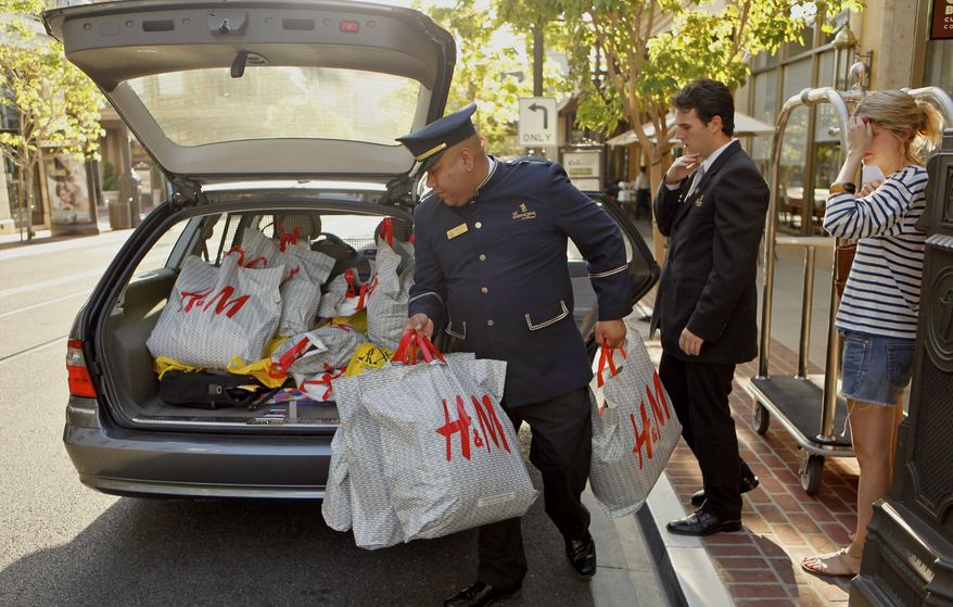 A concierge and a valet assist a shopper in loading purchases into her car at the Americana at Brand Mall on Monday, Aug. 30, 2010, in Glendale, Calif. (AP Photo/Damian Dovarganes)