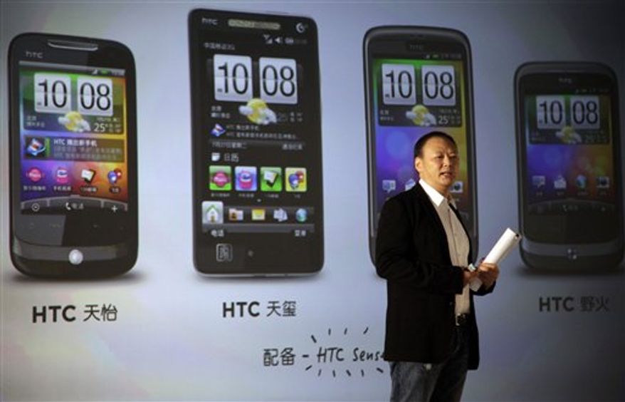 FILE - In this July 27, 2010 file photo, Peter Chou, chief executive officer of Taiwan's High Tech Computer Corp., or HTC Corp., talks about the introduction of the brand into China's market during a press conference held in Beijing, China. East Asia is the world's electronics factory, yet unless they are Japanese, producers are anonymous. Now HTC Corp., the Taiwanese maker of smart phones, is moving out of the shadows and trying to establish its own brand name as it competes with Apple's iPhone. (AP Photo/Ng Han Guan, File)