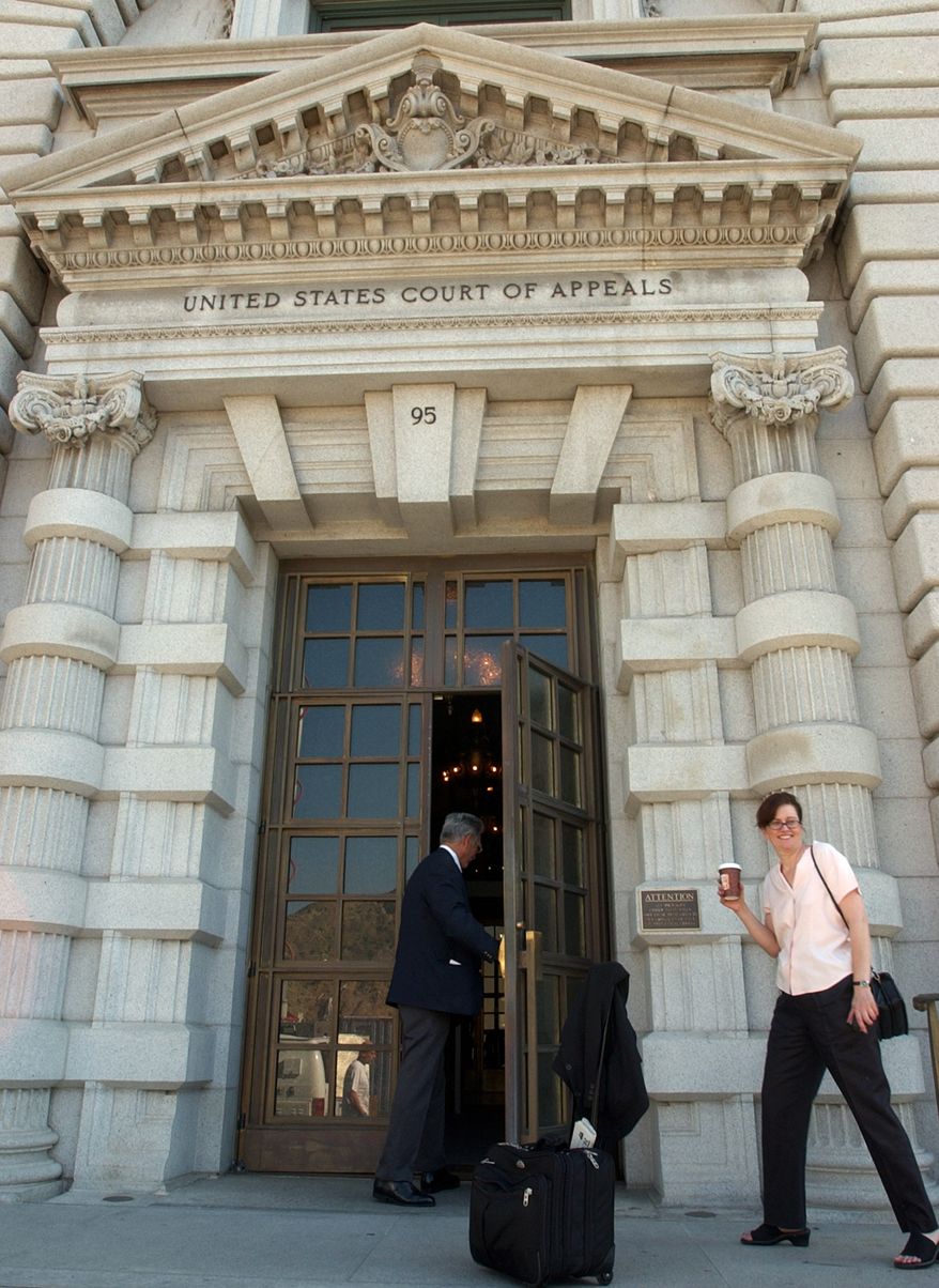A woman waits to get into the 9th U.S. Circuit Court of Appeals building in San Francisco, in this Sept. 22, 2003 file photo. A sharply divided 9th U.S. Circuit Court of Appeals Wednesday, Sept. 8, 2010, threw out a lawsuit that challenged Boeing Co.'s role flying terrorism suspects to secret prisons and raised questions about the government's ability to quash lawsuits when state secrets are involved. (AP Photo/Paul Sakuma, File)