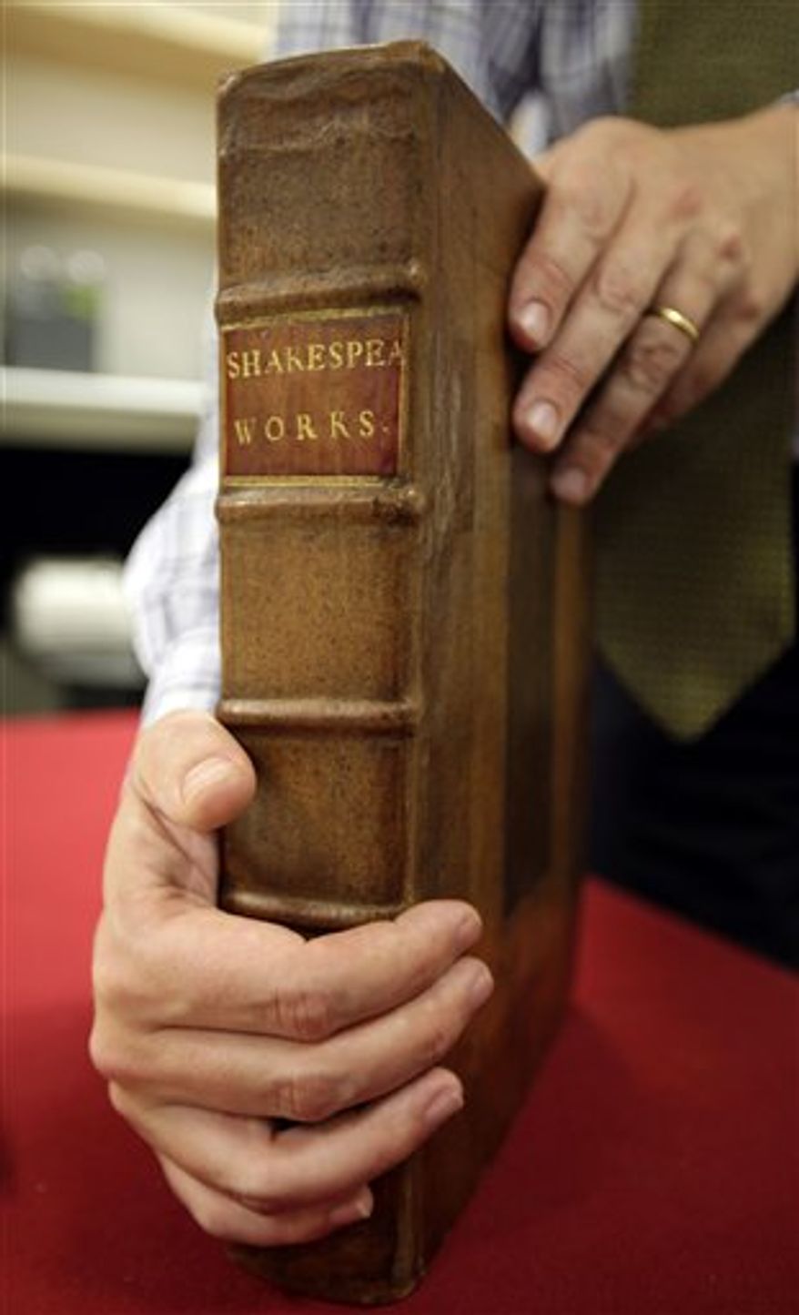 Sotheby's auction house worker Mary Engleheart, goes through a rare copy of a book of illustrations by John James Audubon's "Birds of America," in central London, Thursday Sept. 9, 2010. The collection of 435 hand-colored prints, made from engravings of Audubon's illustrations, measures more than 3 feet by 2 feet (90 centimeters by 60 centimeters) because Audubon wanted to paint the birds life size. According to the house, the book of four volumes could reach 6 million pounds ($9.25 million) when it is auctioned in the Magnificent Books, Manuscripts and Drawings from the Collection of Frederick, 2nd Lord Hesketh sale which will take place at Sotheby's in London on Dec. 7, 2010. (AP Photo/Lefteris Pitarakis)