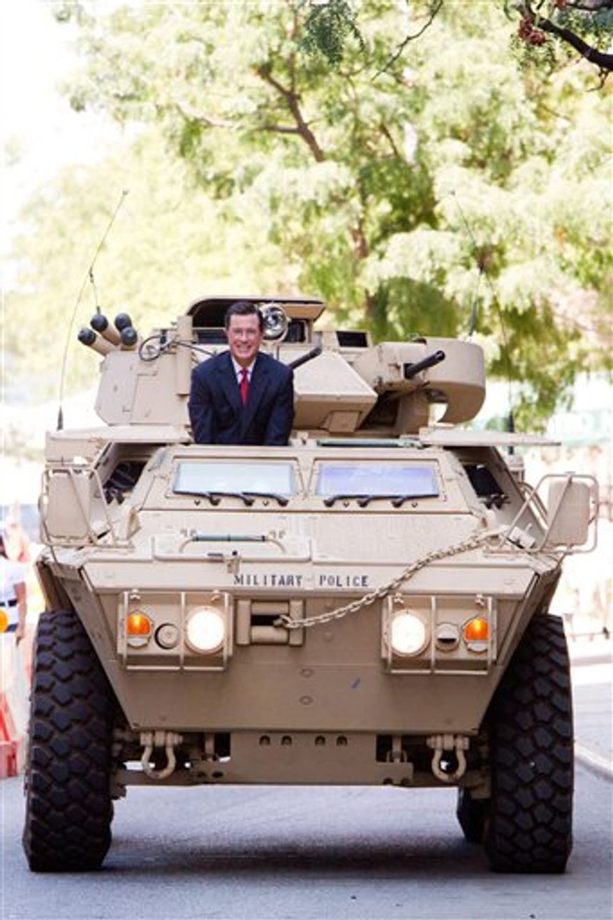 Stephen Colbert rides an Army ASV while taping an episode of the Colbert Report on West 54th Street in New York, Wednesday, September 8, 2010. (AP Photo/Charles Sykes)