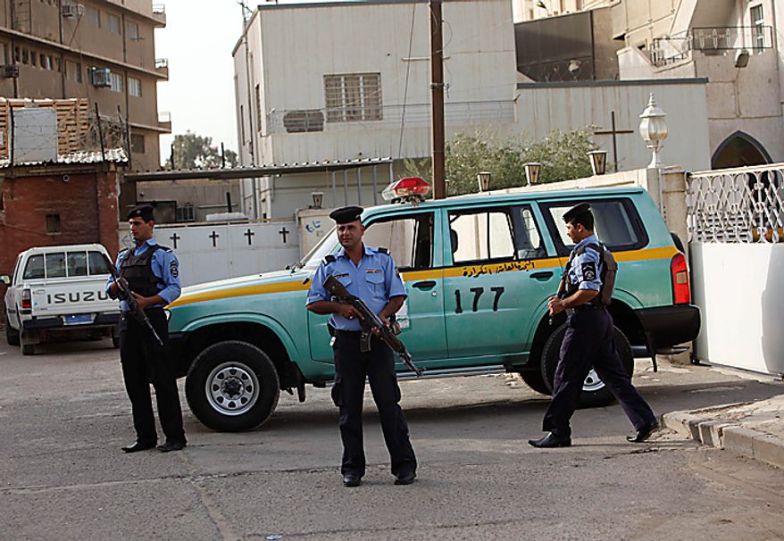 Iraqi policemen stand guard outside Evangelical Protestant churchin Baghdad, Iraq, Thursday, Sept. 9, 2010. There are fears of a backlash against Christians in predominantly Muslim countries. Canon Andrew White, the chaplain of an Anglican church in Baghdad, said the Iraqi military had warned him that his church had been threatened. Security was beefed up around the Church of Virgin Mary in central Baghdad on Thursday, with military vehicles blocking the entrance to the church and more soldiers were deployed to guard it. (AP Photo/Khalid Mohammed)