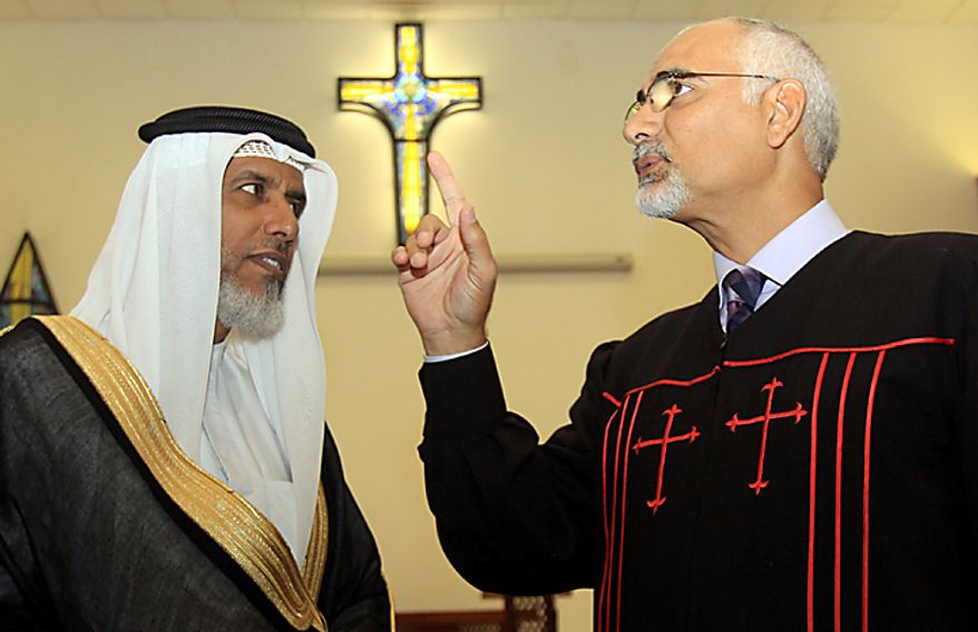 The Rev. Hani Aziz, right, speaks of the one God of Muslim and Christian beliefs, during a statement Thursday, Sept. 9, 2010, to journalists delivered with Muslim cleric Sheikh Salah bin Yousuf al-Jowder, left, at the National Evangelical Church in Manama, Bahrain. The men denounced a Florida preacher's planned Sept. 11 Quran-burning, as a "detestable act." (AP Photo/Hasan Jamali)