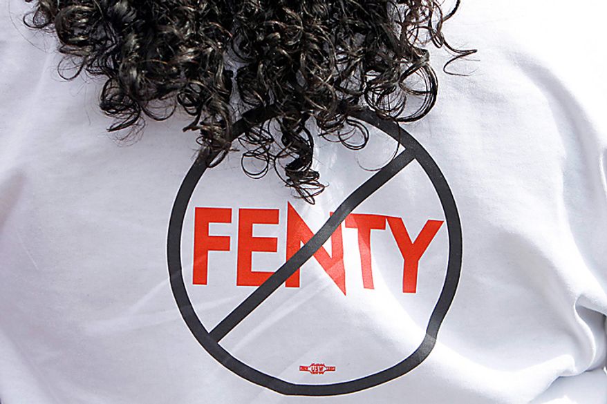 Alya Solomon, of Washington, wears a shirt opposing District of Columbia Mayor Adrian Fenty outside the polling station in Washington, Tuesday Sept. 14, 2010, as Washington held its mayoral primary. (AP Photo/Jacquelyn Martin)