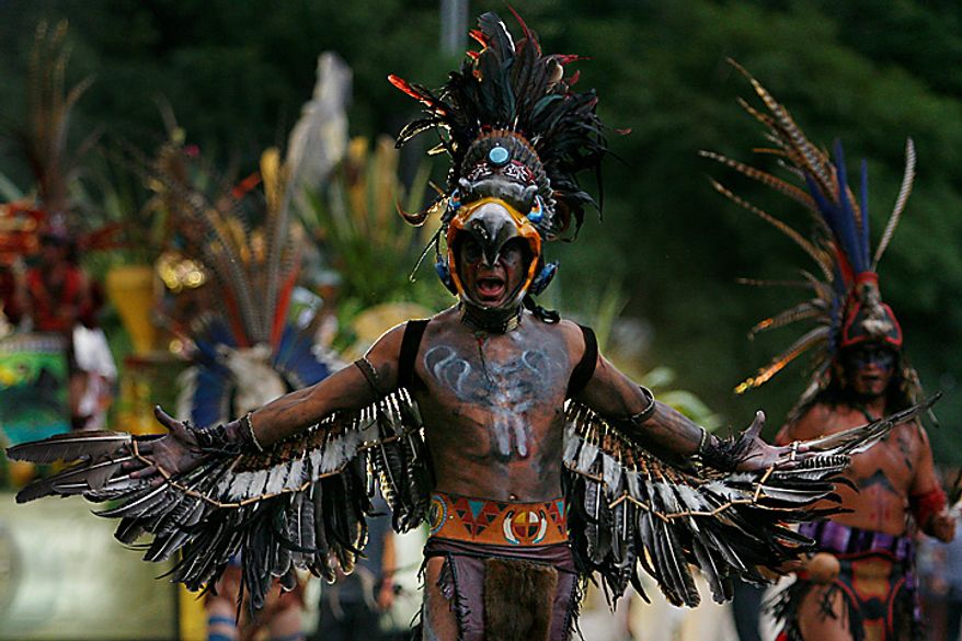 Men wearing Aztec costumes perform during the bicentennial parade in Mexico City, Wednesday Sept. 15, 2010. Mexico celebrates the 200th anniversary of its 1810 independence uprising. (AP Photo/Miguel Tovar)