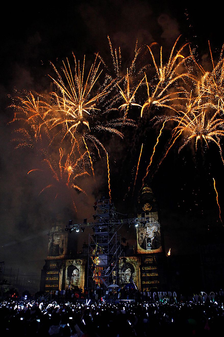 Fireworks explode over the Metropolitan Cathedral during bicentennial celebrations at the Zocalo in Mexico City, Wednesday Sept. 15, 2010. Mexico celebrates the 200th anniversary of its 1810 independence uprising.(AP Photo/Alexandre Meneghini)