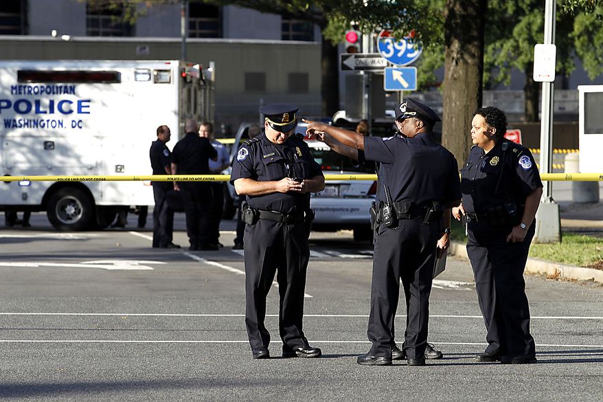 Police officers at the scene of a shooting on Capitol Hill in Washington on Friday, Sept. 17, 2010. Authorities in Washington say police shot a man who pointed a gun at them on Capitol Hill. (AP Photo/Jose Luis Magana)