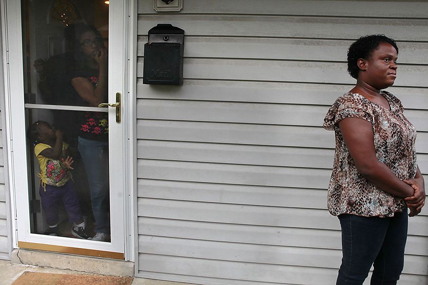 Teresa Green, right, a neighbor of Paul Warren Pardus, is interviewed at her home as her family members watch in Arlington, Va. on Thursday, Sept. 16, 201. Pardus became distraught as he was being briefed on his mother's condition by a surgeon at Johns Hopkins Hospital in Baltimore, pulled a gun and shot the doctor Thursday, then killed his mother and himself in her room at the world-famous medical center, police said. (AP Photo/Jacquelyn Martin)