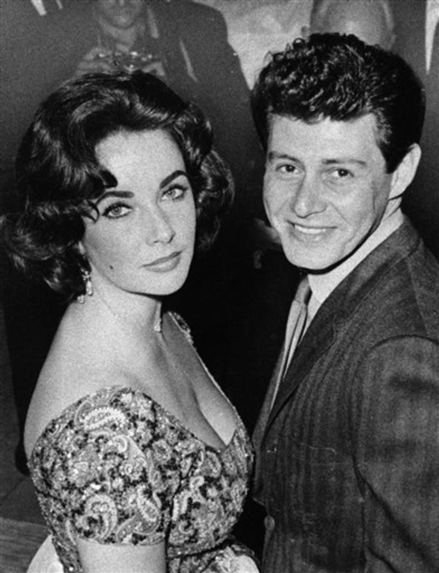 FILE - In this Sept. 26, 1955 file photo, actress Debbie Reynolds and singer Eddie Fisher smile in a pose following their brief marriage ceremony by a county judge at Grossinger, N.Y. Fisher, whose huge fame as a pop singer was overshadowed by scandals ending his marriages to Debbie Reynolds and Elizabeth Taylor, died Wednesday night Sept. 22, 2010 of complications from hip surgery at a hospital in Berkeley. He was 82. (AP Photo/Marty Lederhandler, File)