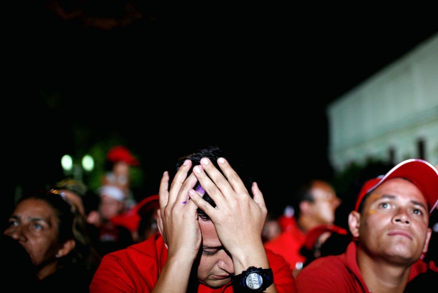 Supporters of Venezuelan President Hugo Chavez react Monday in Caracas to results of congressional elections Sunday. Mr. Chavez lost a significant number of allies in the National Assembly. (Associated Press)