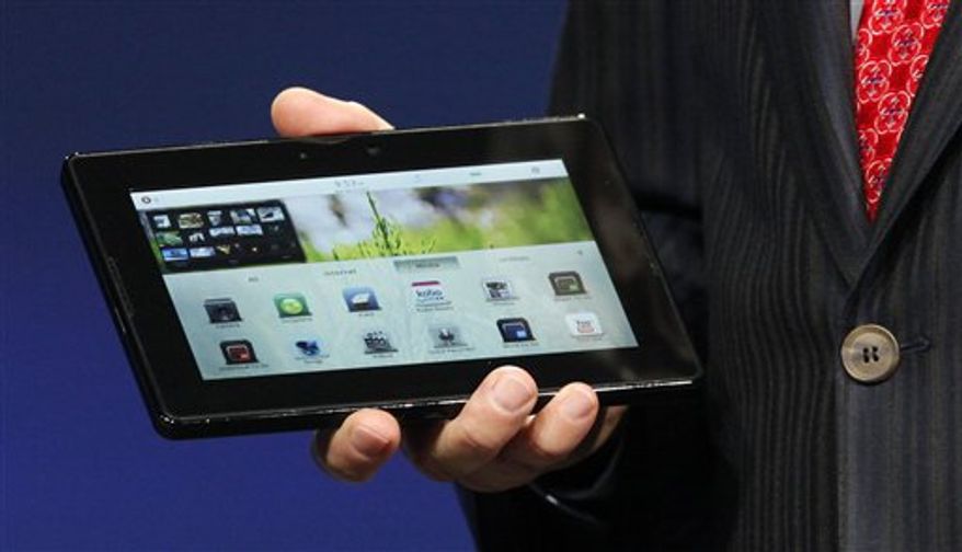 Mike Lazaridis, president and co-CEO of Research in Motion Ltd. (RIM), holds the new PlayBook during the BlackBerry developers conference 2010 in San Francisco, Monday, Sept. 27, 2010. RIM showed off the tablet for the first time and is set to launch it early 2011, with an international rollout later in the year. With it RIM is betting on a smaller, lighter device than Apple Inc.'s iPad, which kicked-started the tablet market when it launched in April. (AP Photo/Jeff Chiu)