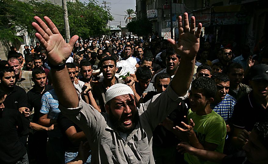Palestinian mourners carry the body of Alaa Abu Zbeedh, 25, during his funeral in the al-Bureij refugee camp in central Gaza on September 28, 2010. Israeli air strikes in Gaza killed three men Palestinian medics said. UPI/Ismael Mohamad