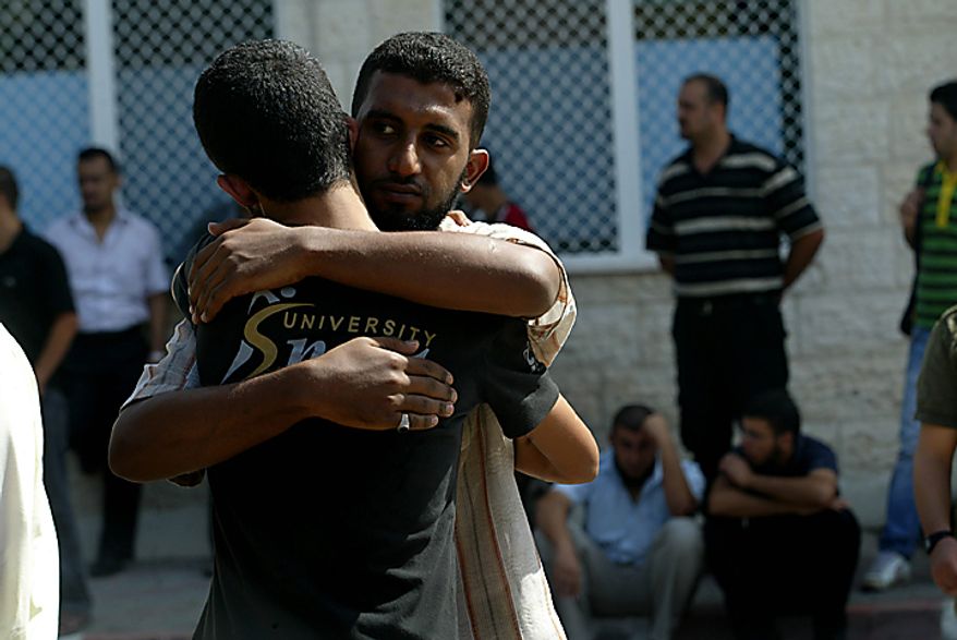 Relatives of three Palestinians who were killed overnight in an Israeli air raid on southern Gaza gather near a hospital in the Gaza town of Deir al-Balah on Sepember 28, 2010. UPI/Ismael Mohamad