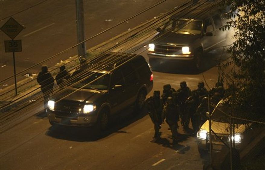Soldiers arrive to enter the police hospital where Ecuador's President Rafael Correa is being holed up by protesting police in Quito, Ecuador, Thursday Sept. 30, 2010. The army rescued Correa from the hospital where he had been trapped by rebellious police for more than 12 hours while he was being treated for tear-gas fired by hundreds of police angry over a law that they claim would cut their benefits. (AP Photo/Dolores Ochoa)