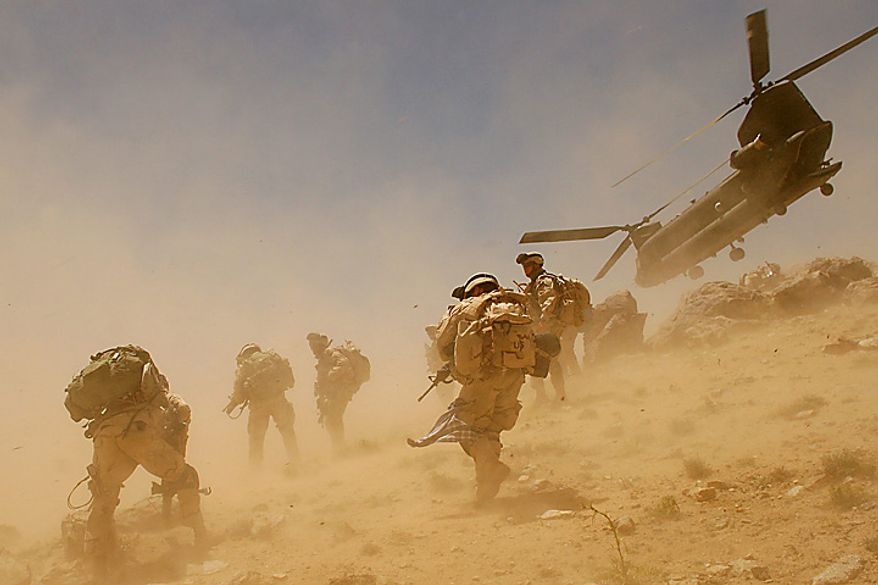 In this Sunday, June 26, 2005 file picture, a CH-47 Chinook helicopter lifts off after dropping off soldiers in the village of Bagh in the Khakeran Valley, Zabul province, Afghanistan. (AP Photo/Tomas Munita, File)