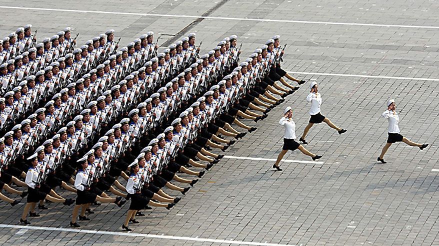 In this photo released by China's Xinhua news agency, North Korean women soldiers march during a massive military parade marking the 65th anniversary of the communist nation's ruling Workers' Party in Pyongyang, North Korea on Sunday, Oct. 10, 2010. This year's celebration comes less than two weeks after Kim Jong Il's re-election to the party's top post and the news that his 20-something son would succeed his father and grandfather as leader. (AP Photo/Xinhua, Yao Dawei)
