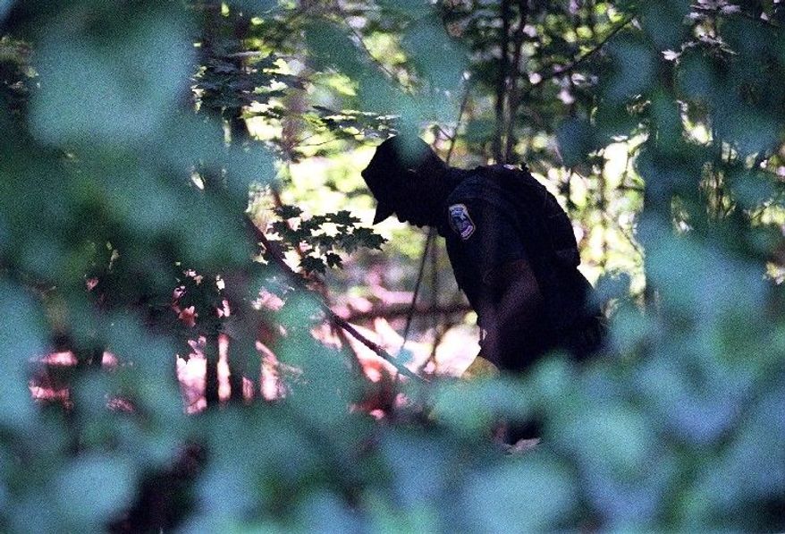 Police search for clues in Rock Creek Park in 2001. (The Washington Times)
