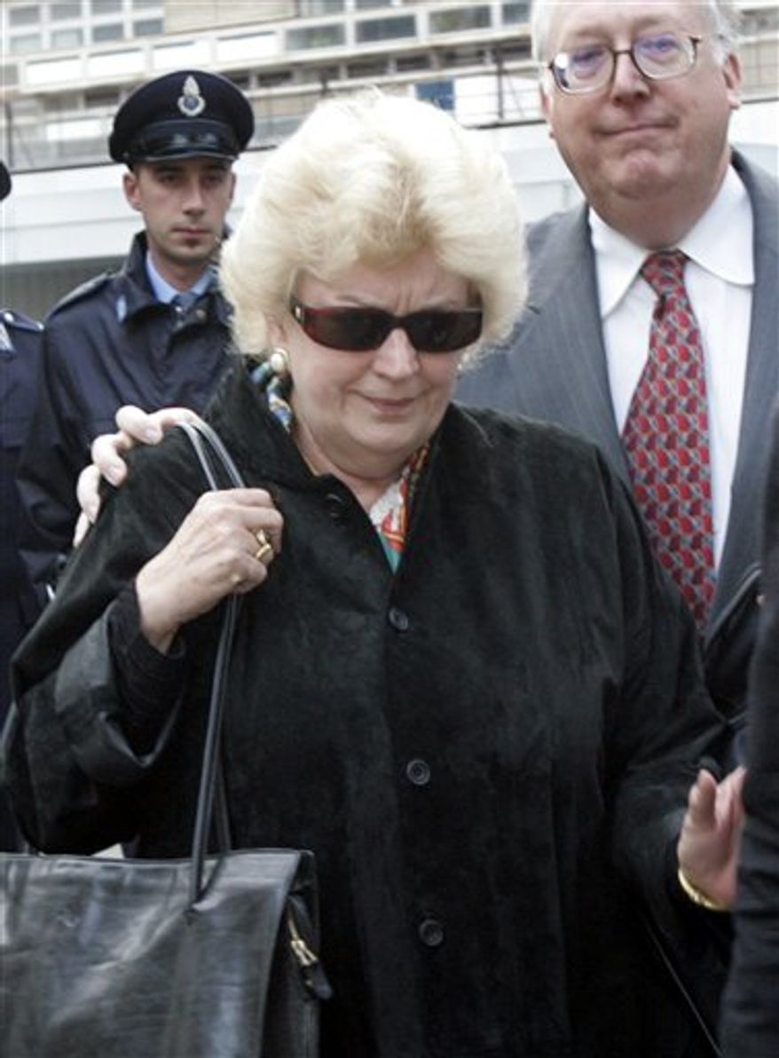 FILE- In this Wednesday, Nov. 16, 2005 file photo, former curator of the J. Paul Getty Museum in California Marion True is escorted by an unidentified lawyer as she leaves a Rome courtroom. A Rome judge on Wednesday, Oct. 13, 2010, declared an end to the six-year-old trial of a former J. Paul Getty Museum antiquities curator Marion True, a case that followed with concern by museums worldwide, because the statute of limitations had expired, defense lawyers said. The case against True involved about 35 artifacts acquired by the museum between 1986 and the late 1990s, including bronze Etruscan pieces, frescoes and painted Greek vessels. (AP Photo/Pier Paolo Cito, File)